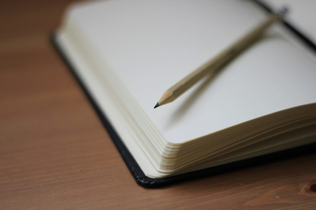 a blank notebook and pen. photo by Jan Kahanek